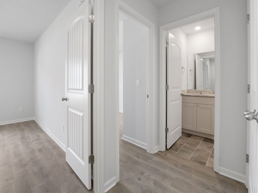 A white door is open to a bathroom.