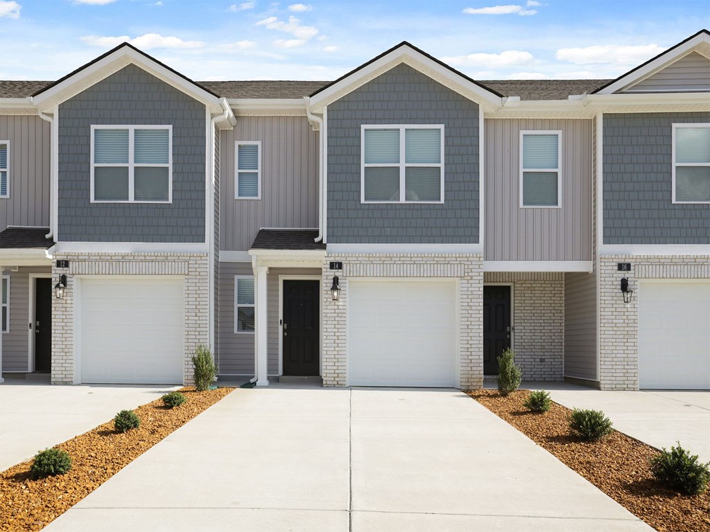 A row of modern houses with garages in front.
