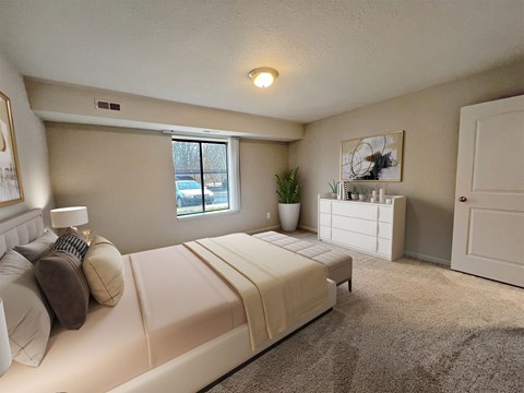 A bedroom with a large bed and a window.