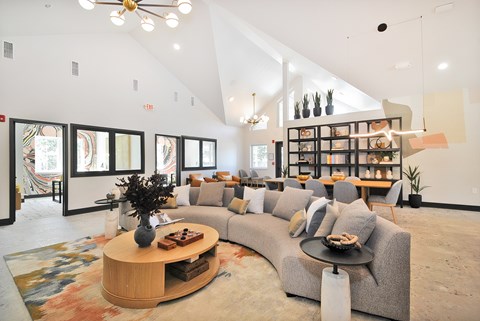 A living room with a grey couch and a wooden coffee table.