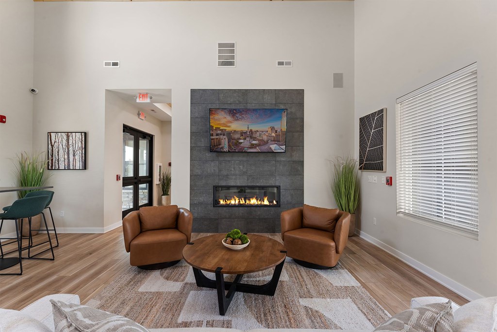 A living room with a fireplace and a painting on the wall.