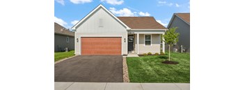 A house with a brown garage door and a white house number.