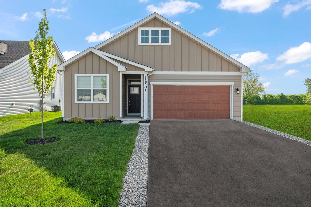 A house with a brown garage door and a driveway.
