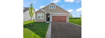 A house with a brown garage door and a driveway.
