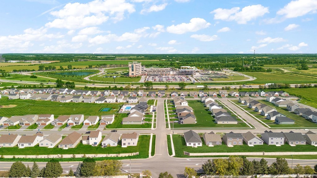 A suburban neighborhood with a large building in the distance.