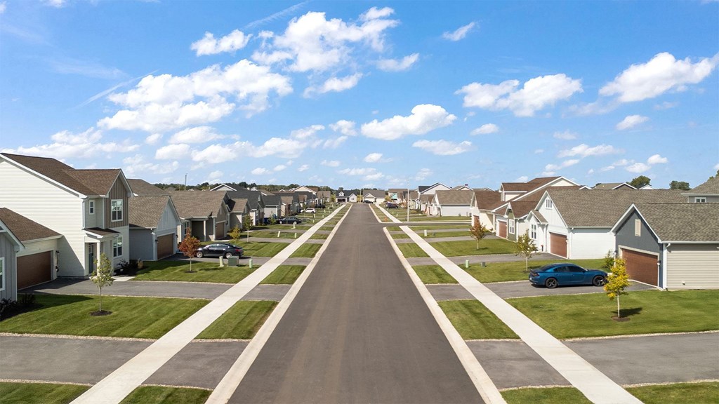 A long residential street with houses on both sides.