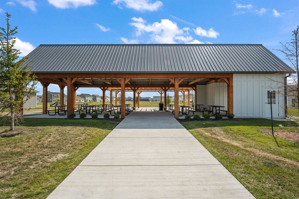 A covered picnic area with a walkway leading to it.