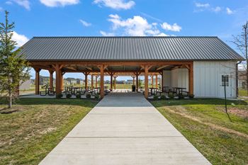 A covered picnic area with a walkway leading to it.