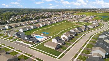 A suburban neighborhood with houses and a swimming pool.