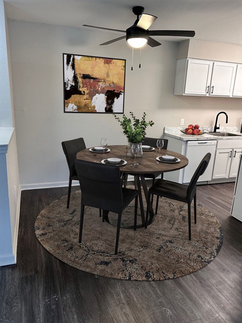A dining room with a table set for four.