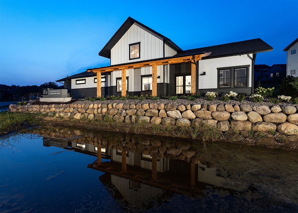 a house reflected in the water at night