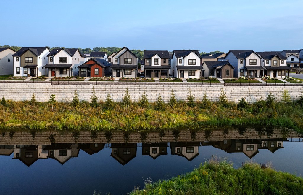 a row of houses reflected in a body of water