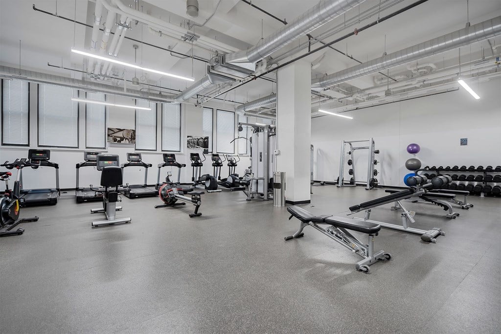 A gym with a variety of exercise equipment.