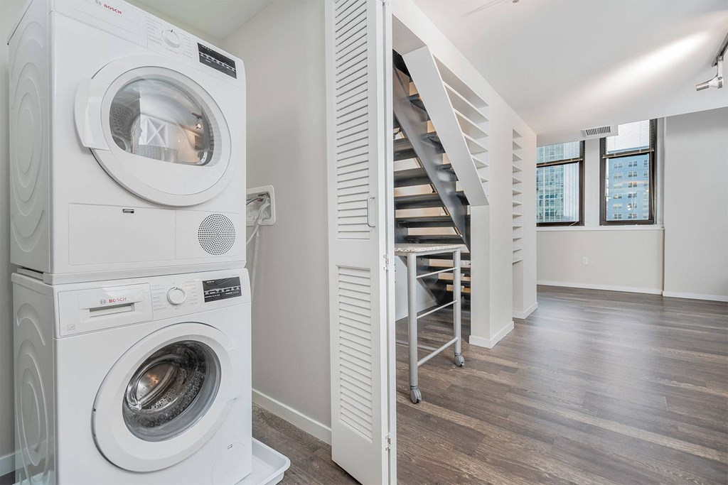 A white washing machine and dryer in a laundry room.
