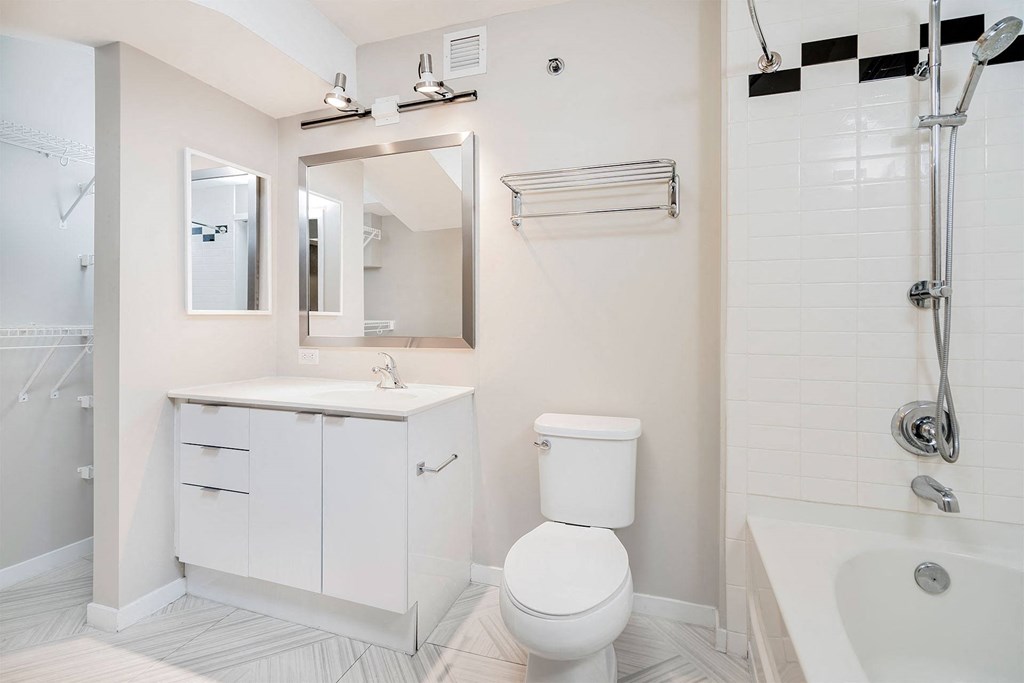 A white bathroom with a toilet, sink, and bathtub.