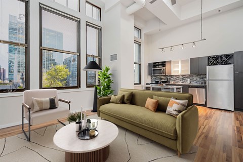 A modern living room with a green sofa and a coffee table.
