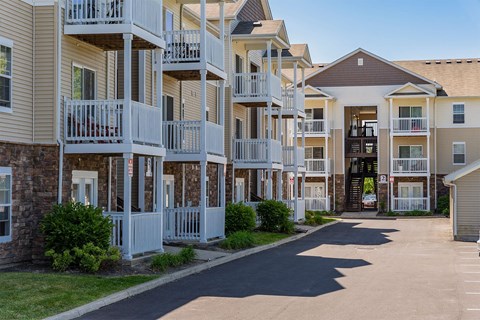 an empty street in front of an apartment building