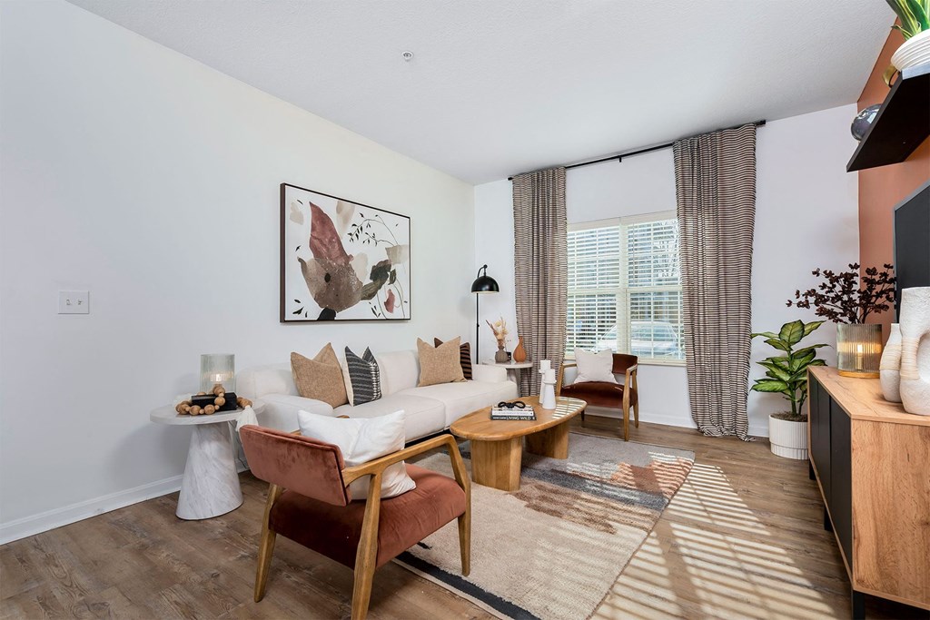 a living room with a white couch and a large window