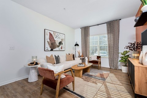 a living room with a white couch and a large window