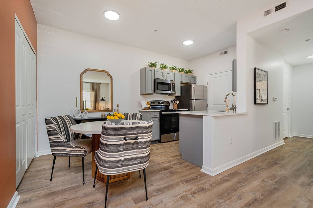 a kitchen and dining room with a table and chairs
