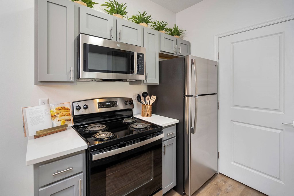a kitchen with stainless steel appliances and white cabinets