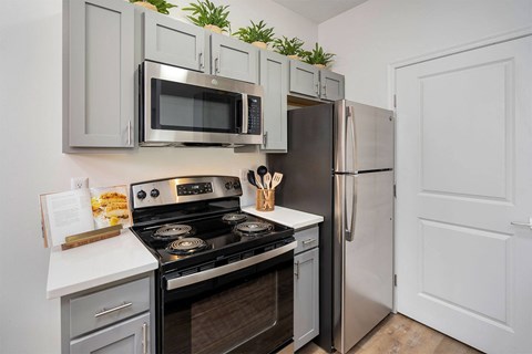 a kitchen with stainless steel appliances and white cabinets