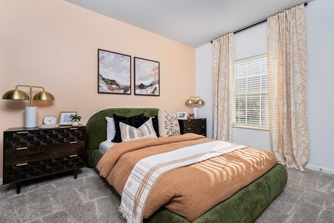 a bedroom with a bed and a large window