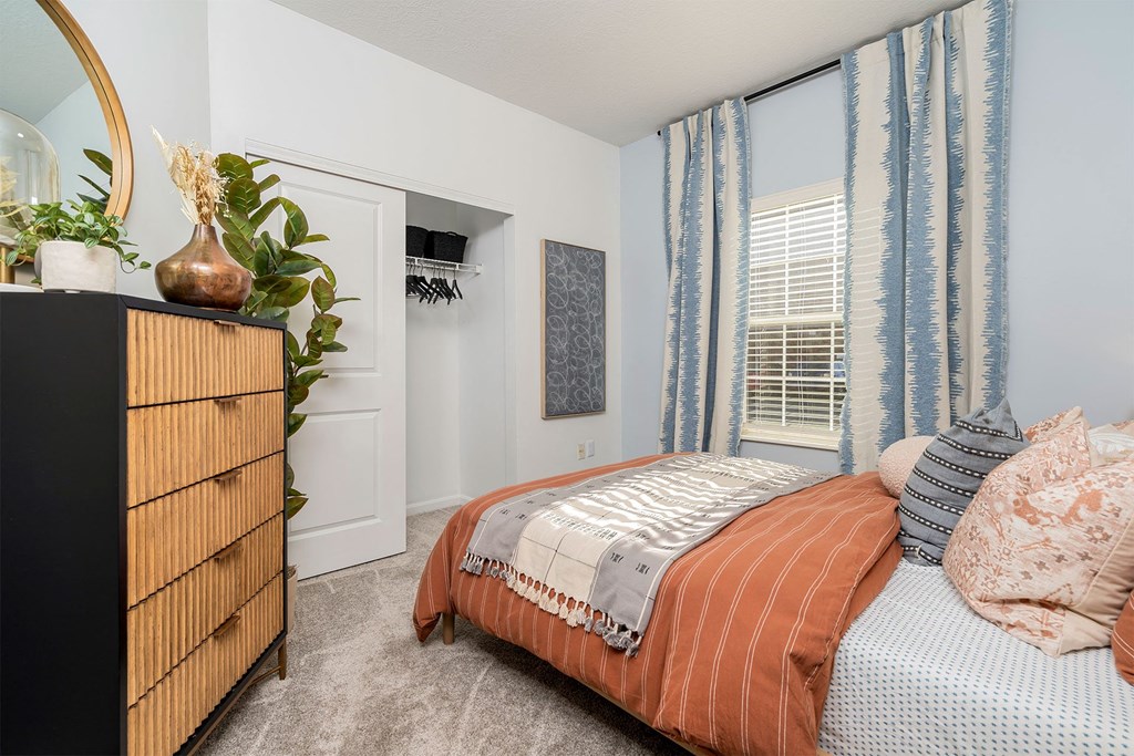 a bedroom with a bed and a dresser