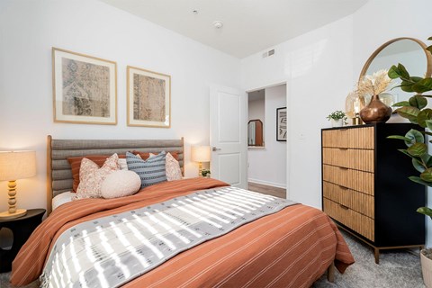 a bedroom with a bed and a dresser