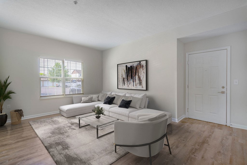 a living room with a white couch and a coffee table