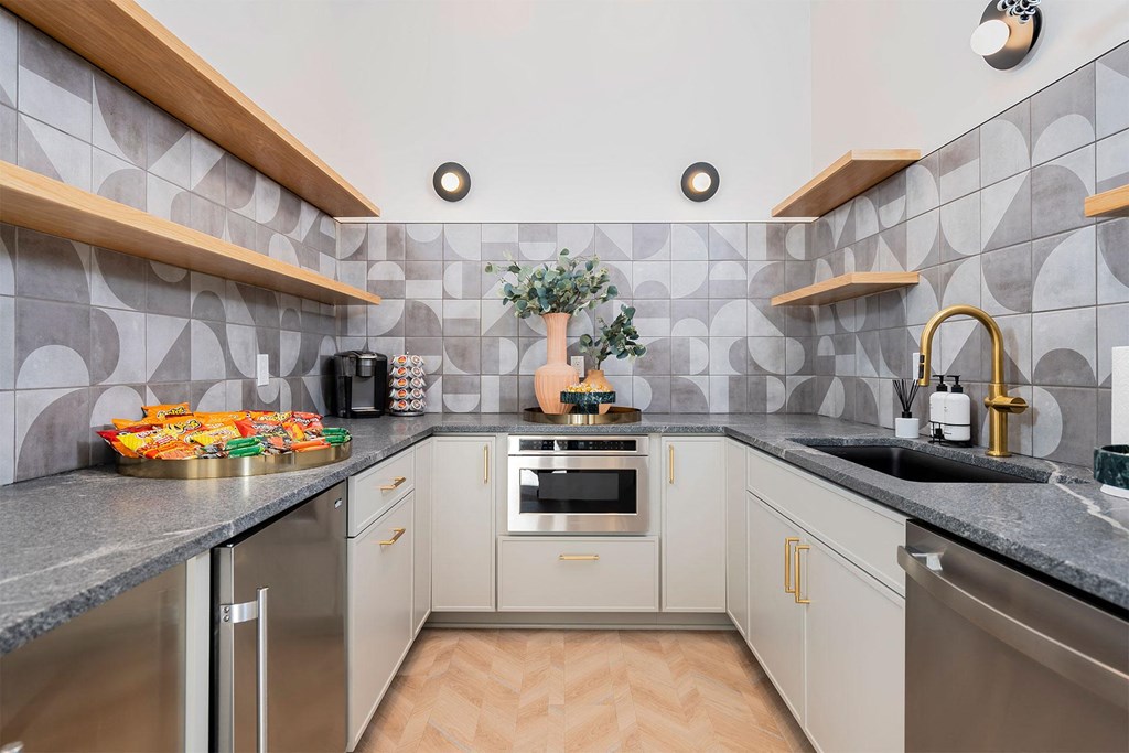 clubhouse kitchen with a sink and a counter top