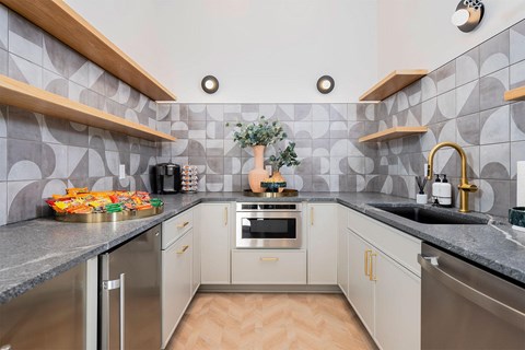clubhouse kitchen with a sink and a counter top