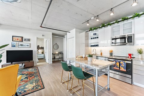 a kitchen with a marble counter top and a dining table
