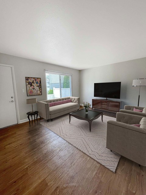 A living room with a couch, chair, and coffee table.