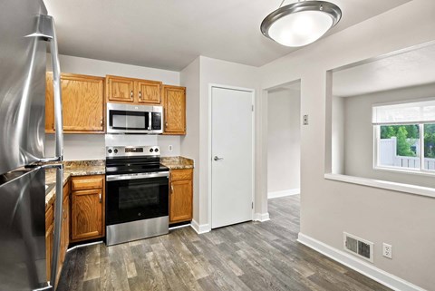 A kitchen with wooden cabinets and stainless steel appliances.