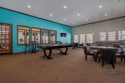A conference room with a long table and chairs.