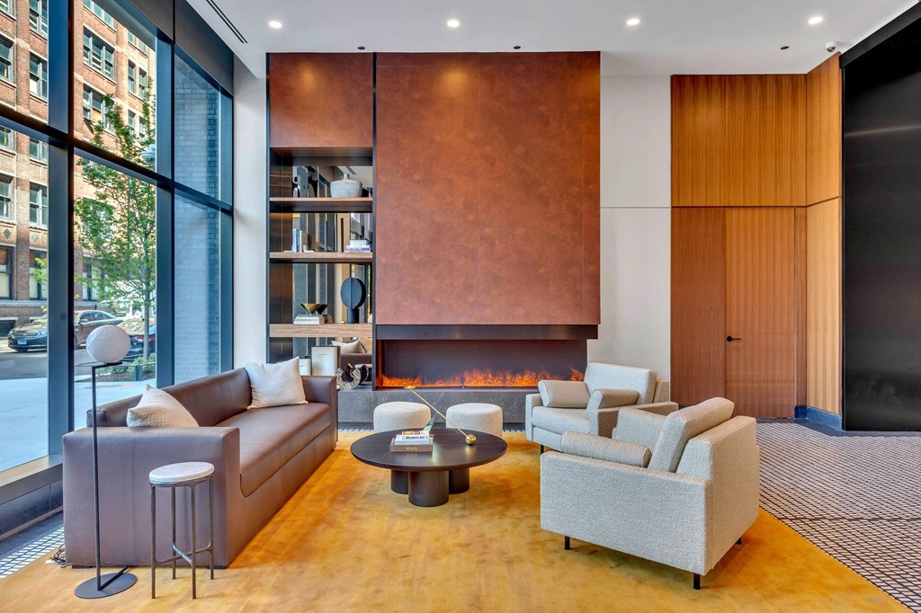 a living room with couches and chairs and a fireplace