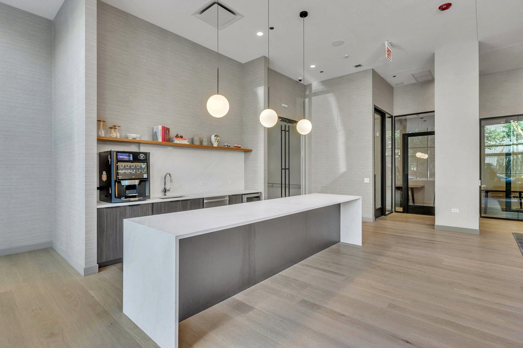 a large kitchen with a large island and a coffee machine