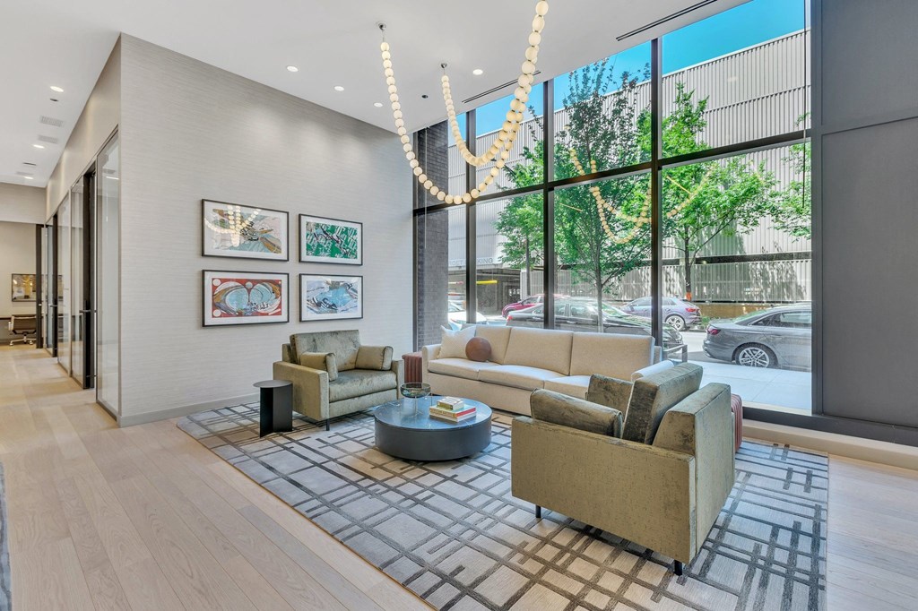 a living room with couches and a coffee table in front of a large window