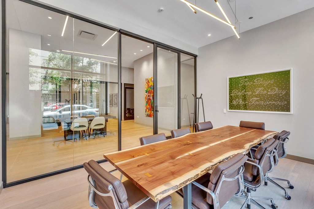a large conference room with a wooden table and chairs
