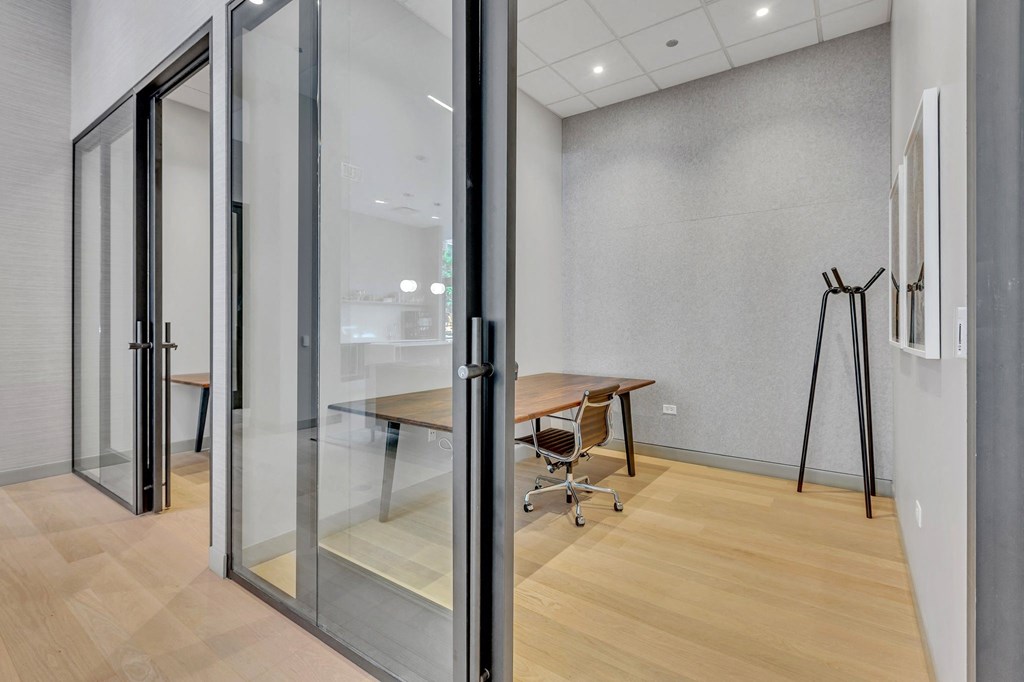 a conference room with glass doors and a wooden floor