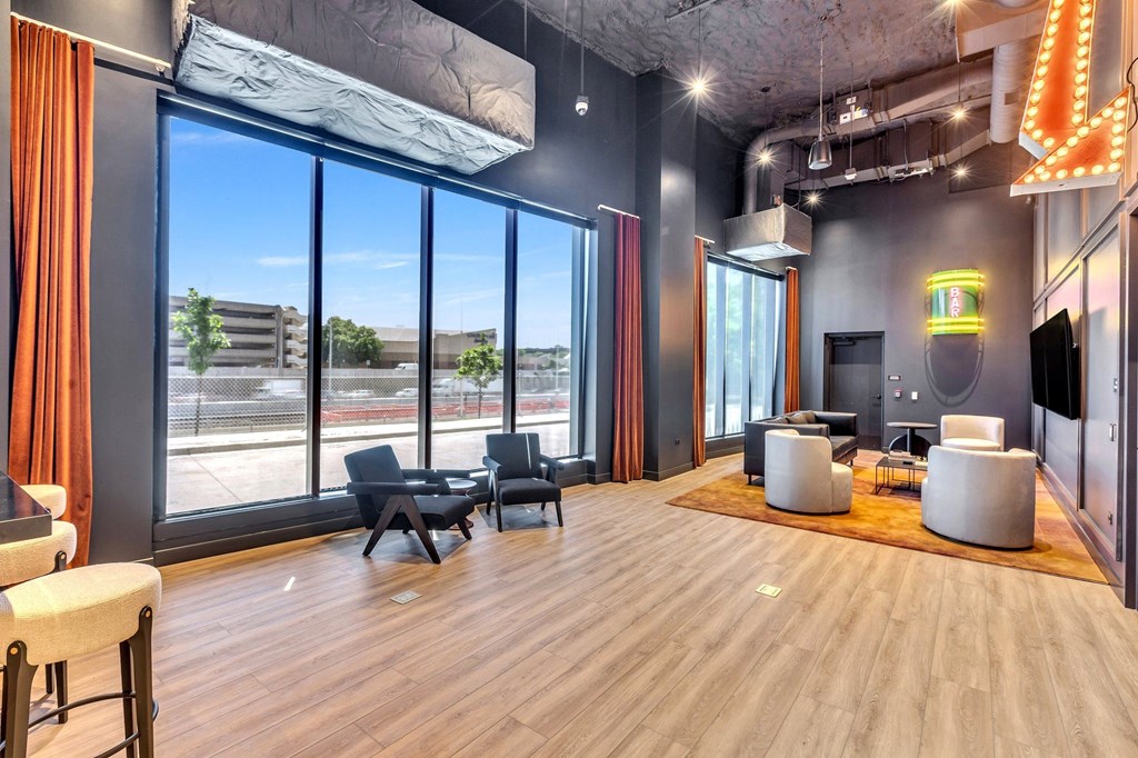 a living room with large windows and a wood floor