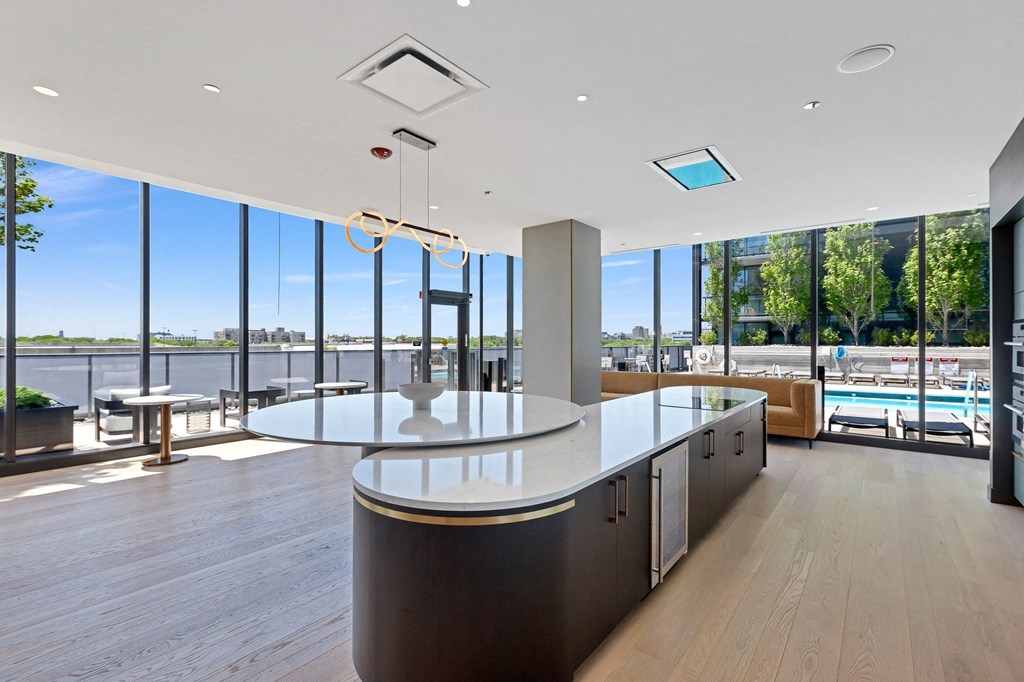 a kitchen with a large window overlooking a body of water