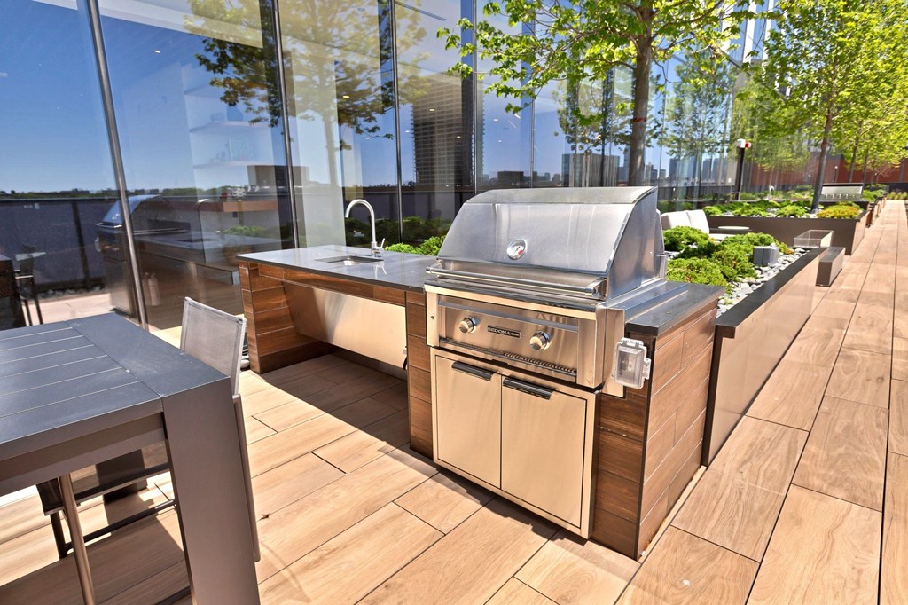 a barbecue grill on a patio with a table
