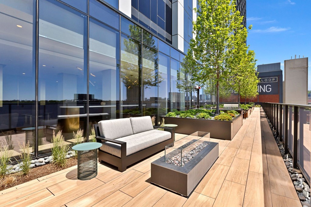 a patio with a couch and a table on a balcony