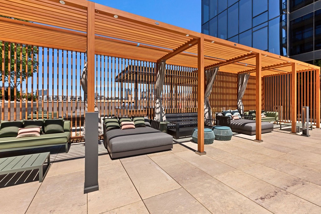 a rendering of a lounge area on the rooftop of a building
