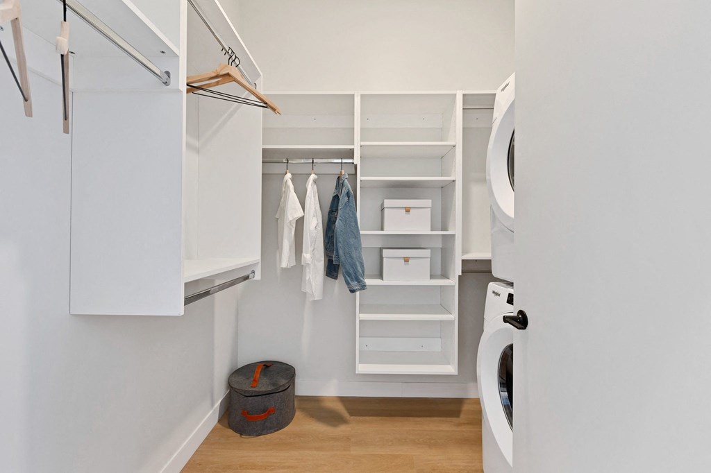 a laundry room with white cabinets and a washer and dryer