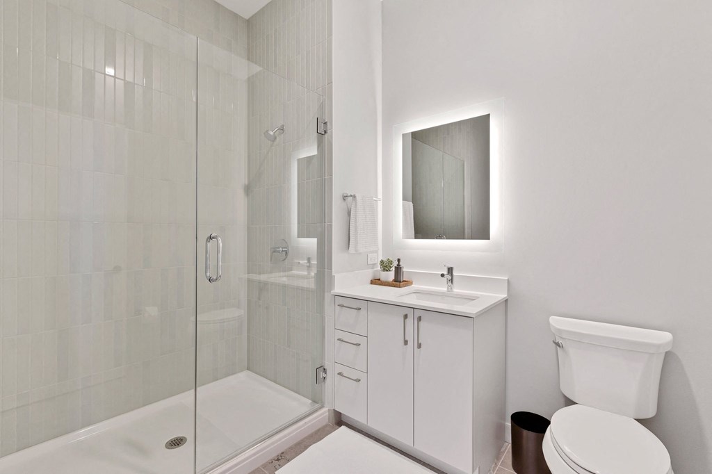 a white bathroom with a shower and a sink