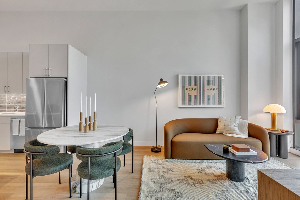 a living room with a table and a couch and a kitchen