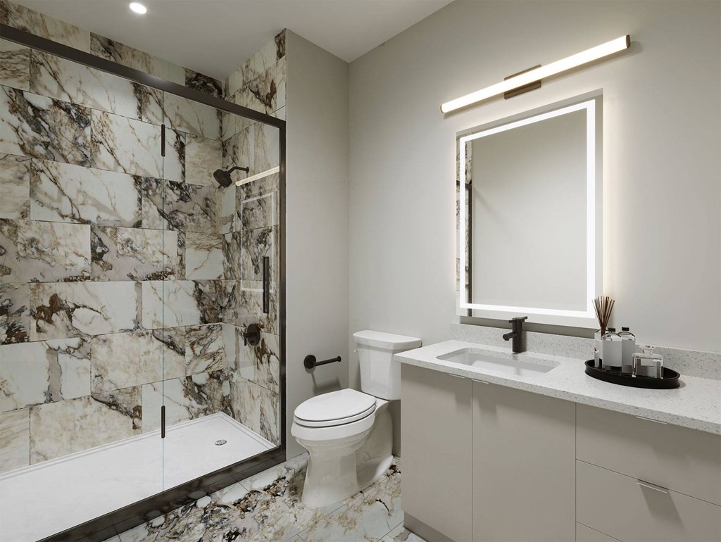 a bathroom with a shower toilet and sink and a mirror